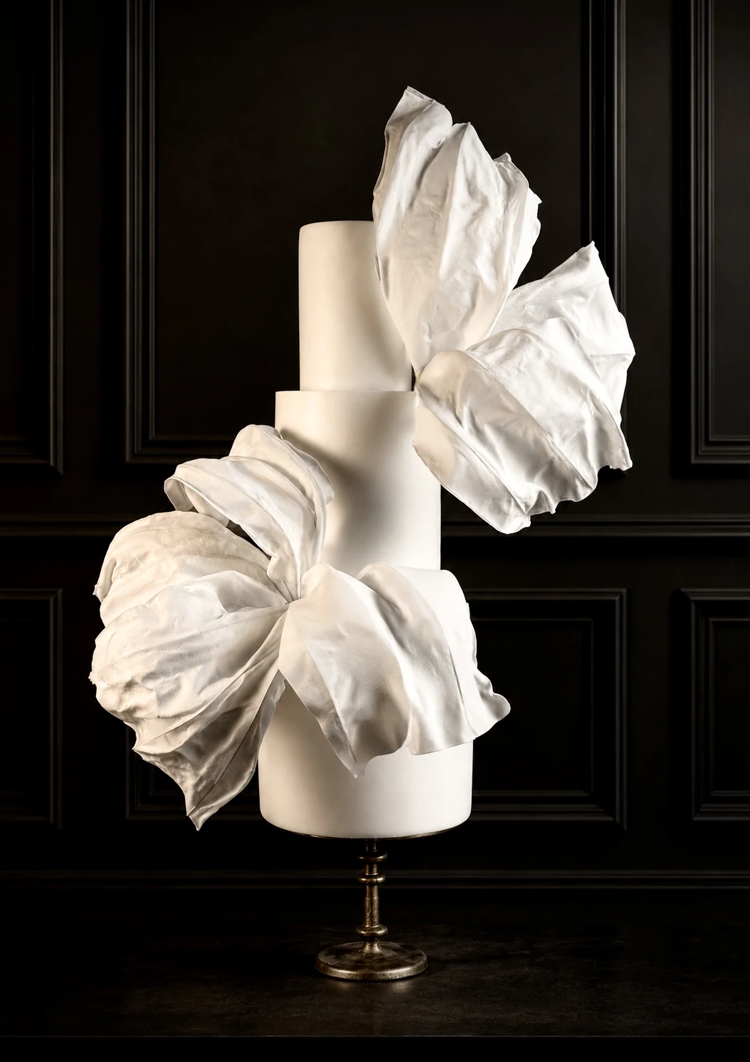 Ivory sculptural wedding cake with oversized edible fabric forms
